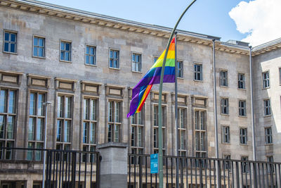 Low angle view of flag against buildings in city
