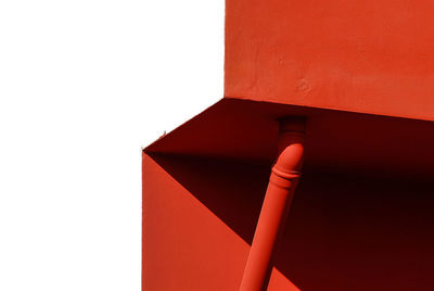 Close-up of red structure against white background