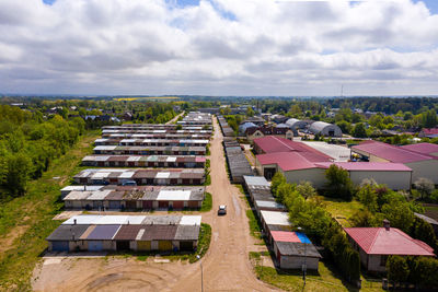 High angle view of buildings in field against sky