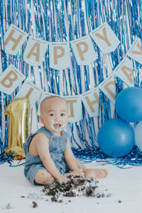 Portrait of boy playing with balloons