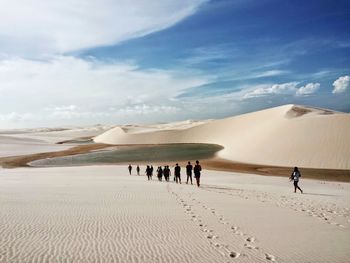 People walking on sand dune in desert