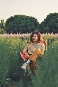 Portrait of woman sitting on field