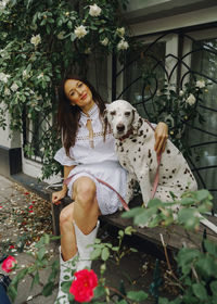 Portrait of woman with dog on street