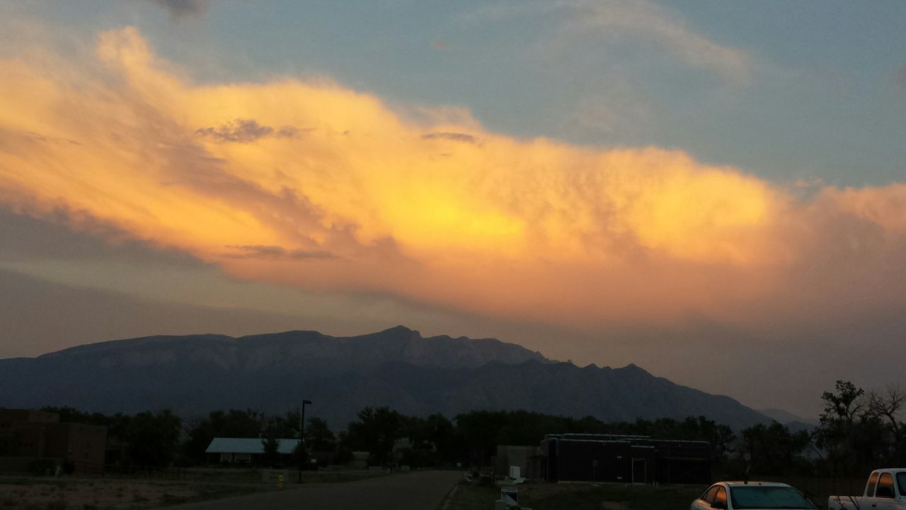 mountain, sky, sunset, cloud - sky, mountain range, scenics, beauty in nature, cloudy, transportation, building exterior, car, road, cloud, nature, built structure, house, landscape, architecture, tranquil scene, tranquility