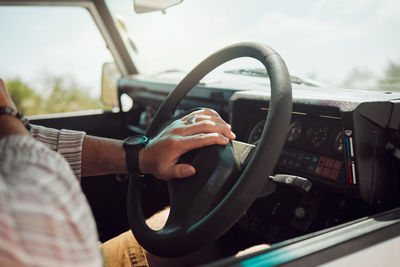 Cropped image of man driving car