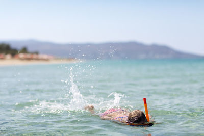 Girl swimming in sea, naxos, greece