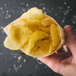 Close-up of hand holding yellow ice cream