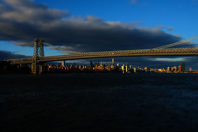 Golden gate bridge over sea against cloudy sky