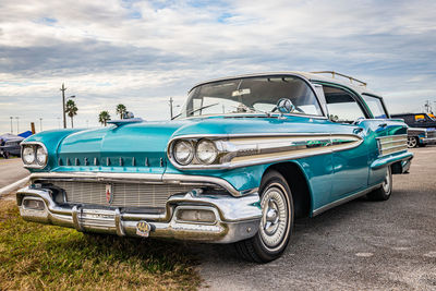 Vintage car on road against sky