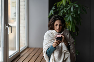 Sick woman consult with medical doctor online using smartphone app suffer from flu virus and fever