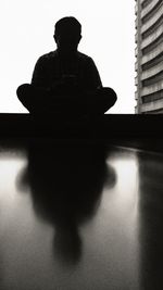 Low angle view of silhouette man against sky