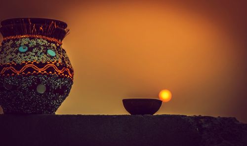 Close-up of electric lamp against sky