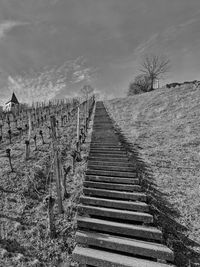 Staircase on field against sky