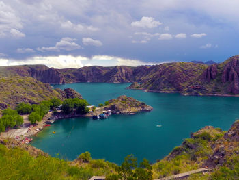 Scenic view of lake against cloudy sky