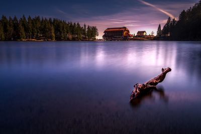 Scenic view of lake against sky at sunset