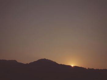 Scenic view of silhouette mountain against sky during sunset