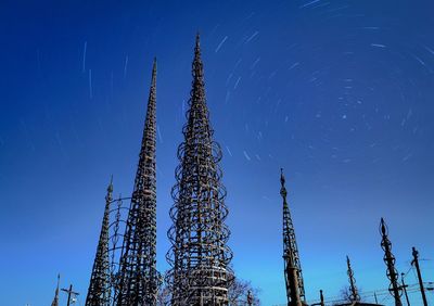 Low angle view of communications tower against blue sky