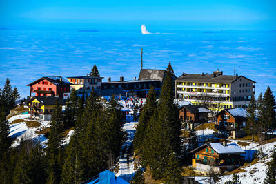 Buildings in city against blue sky