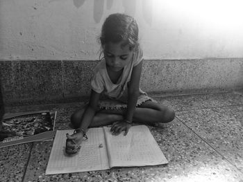 High angle view of girl sitting on staircase