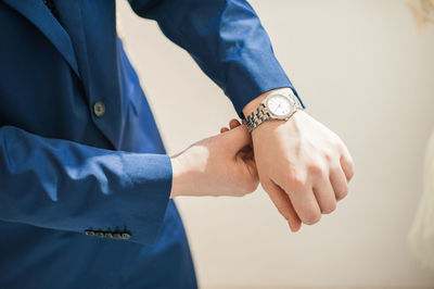 Close-up of wristwatch on hand