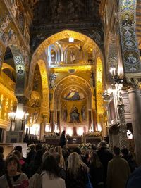 People in illuminated cathedral