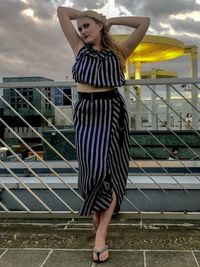 Full length of woman standing on staircase