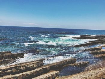 Scenic view of sea against clear blue sky