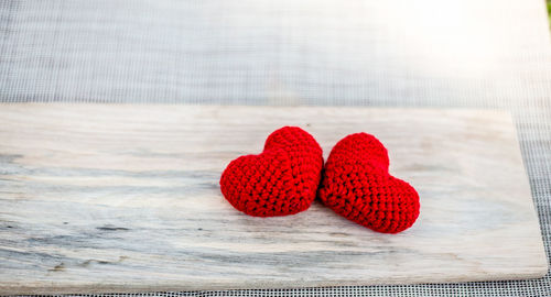 Close-up of heart shape knitted wool on table