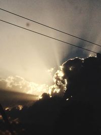 Low angle view of power lines against sky