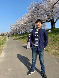 Portrait of young man standing on road