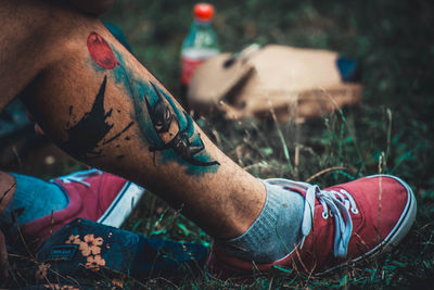 Low section of man with tattoo on leg