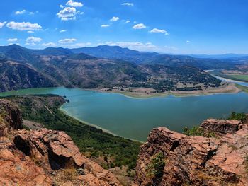 Scenic view of sea and mountains against sky