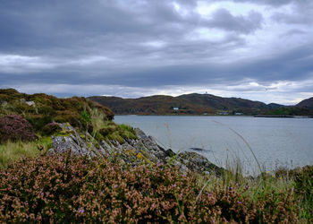 Scenic view of lake and mountains against sky