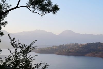 Scenic view of lake and mountains against clear sky