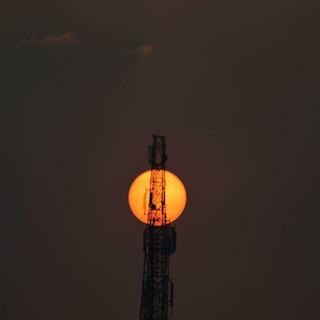 low angle view, lighting equipment, electricity, silhouette, illuminated, copy space, built structure, clear sky, street light, electric light, night, architecture, sky, orange color, technology, sunset, fuel and power generation, dusk, no people, outdoors