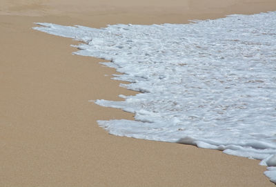Close-up of sand on beach during winter