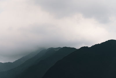 Scenic view of silhouette mountains against sky