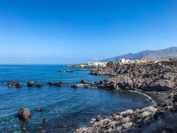 Scenic view of sea against clear blue sky