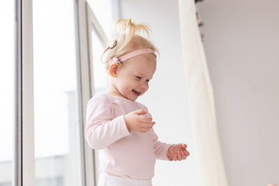 Portrait of cute girl playing with daughter at home