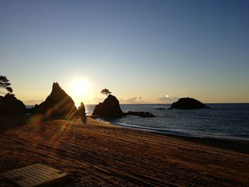 Scenic view of sea against clear sky during sunset