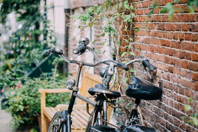 Bicycle leaning on brick wall