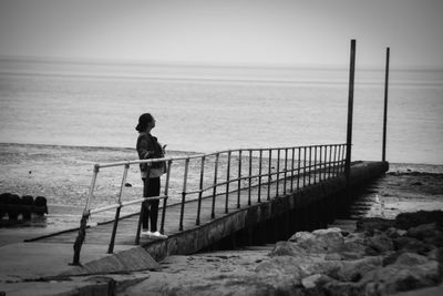 Rear view of man standing on beach