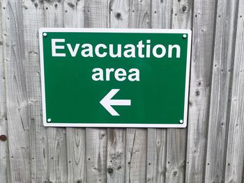 Close-up of road sign on wood