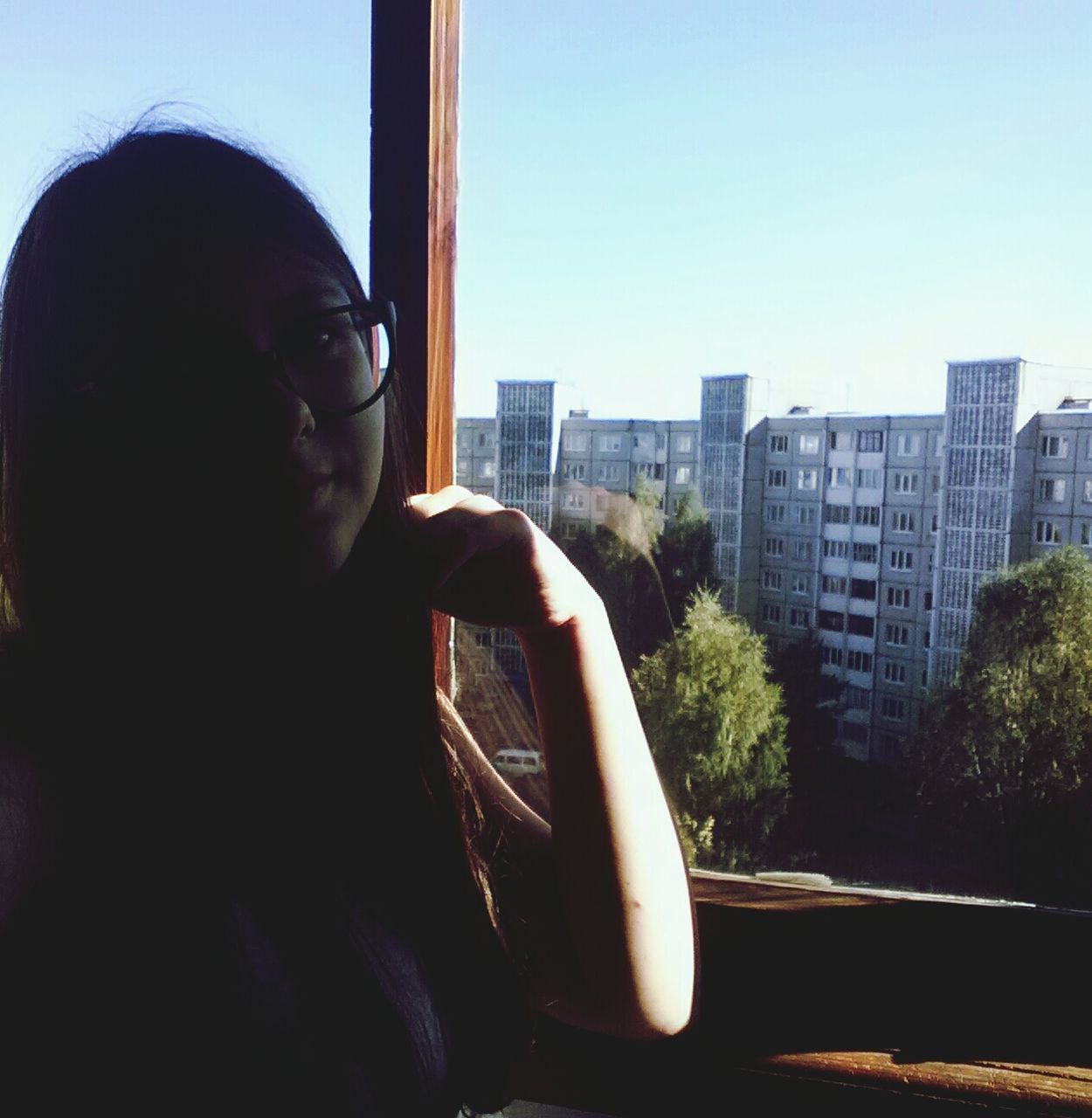 window, architecture, young adult, built structure, building exterior, lifestyles, person, indoors, glass - material, city, sunglasses, leisure activity, looking through window, headshot, side view, transparent, young women, looking away