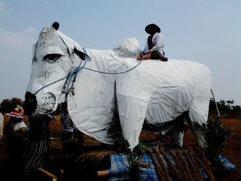 Men in traditional clothing against sky