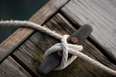 High angle view of rope tied up of cleat on pier
