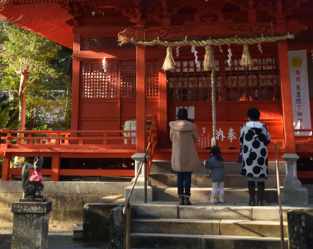 REAR VIEW OF PEOPLE WALKING AT TEMPLE OUTSIDE CATHEDRAL