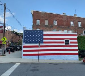 Flag against building in city against sky