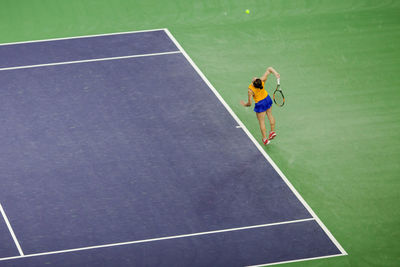 High angle view of woman playing tennis on court