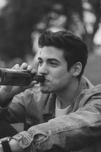 Portrait of young man holding camera